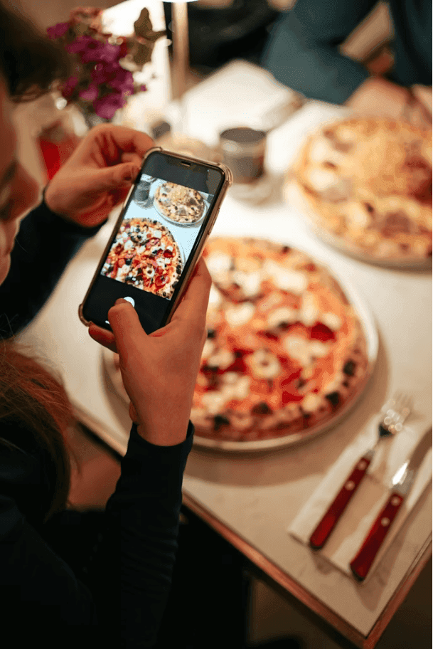 A creator filming a pizza for their followers
